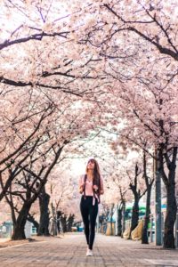 Woman strolling thru park unburdened of financial stress